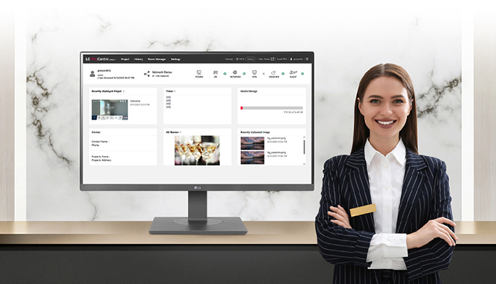The image shows a monitor displaying LG Pro:Centric Direct, accompanied by a hotelier with a smile on her face.