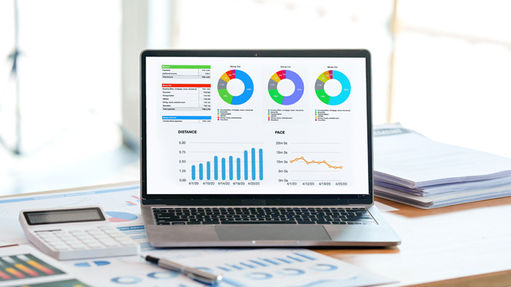 The image shows advertising performance metrics and transaction data being managed on a laptop within the Private Marketplace (PMP) environment of the Programmatic Ad feature provided by the LG DOOH Ads solution.